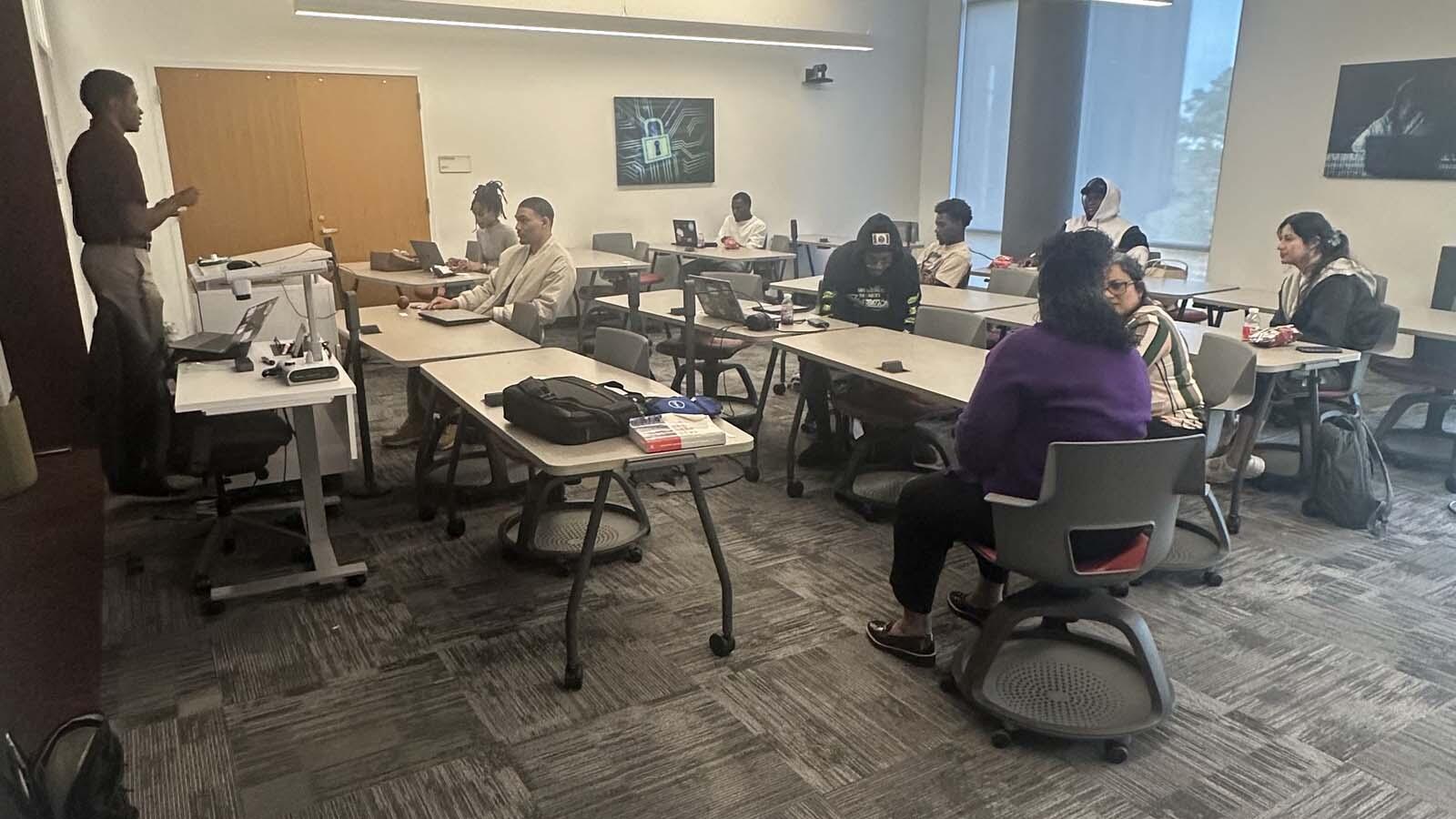 President of IT Eagles delivering a presentation in a classroom full of students