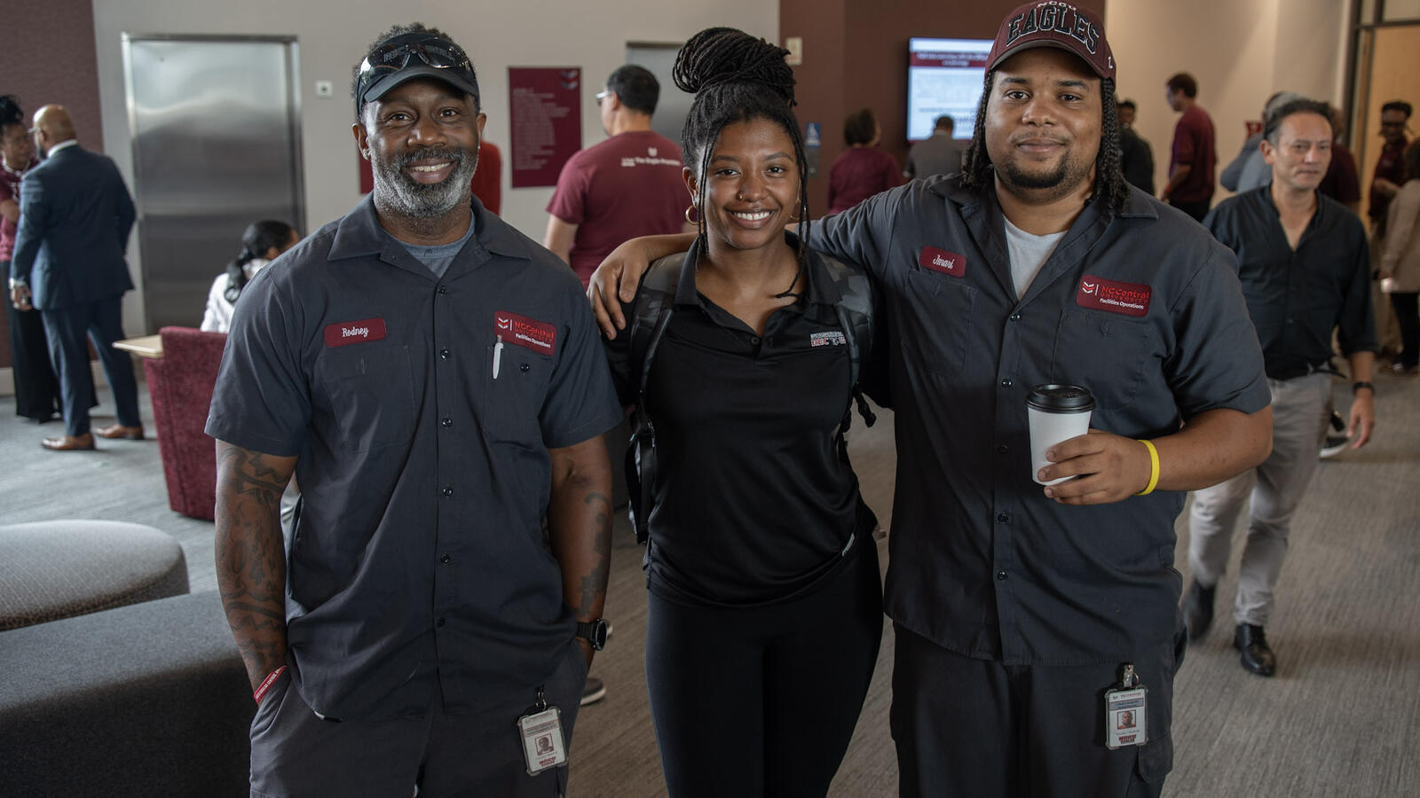 NCCU facilities and campus staff posing together during a university event inside campus building.