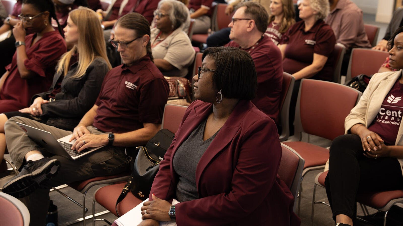 NCCU employees seated in a lecture hall listening to a university training presentation.
