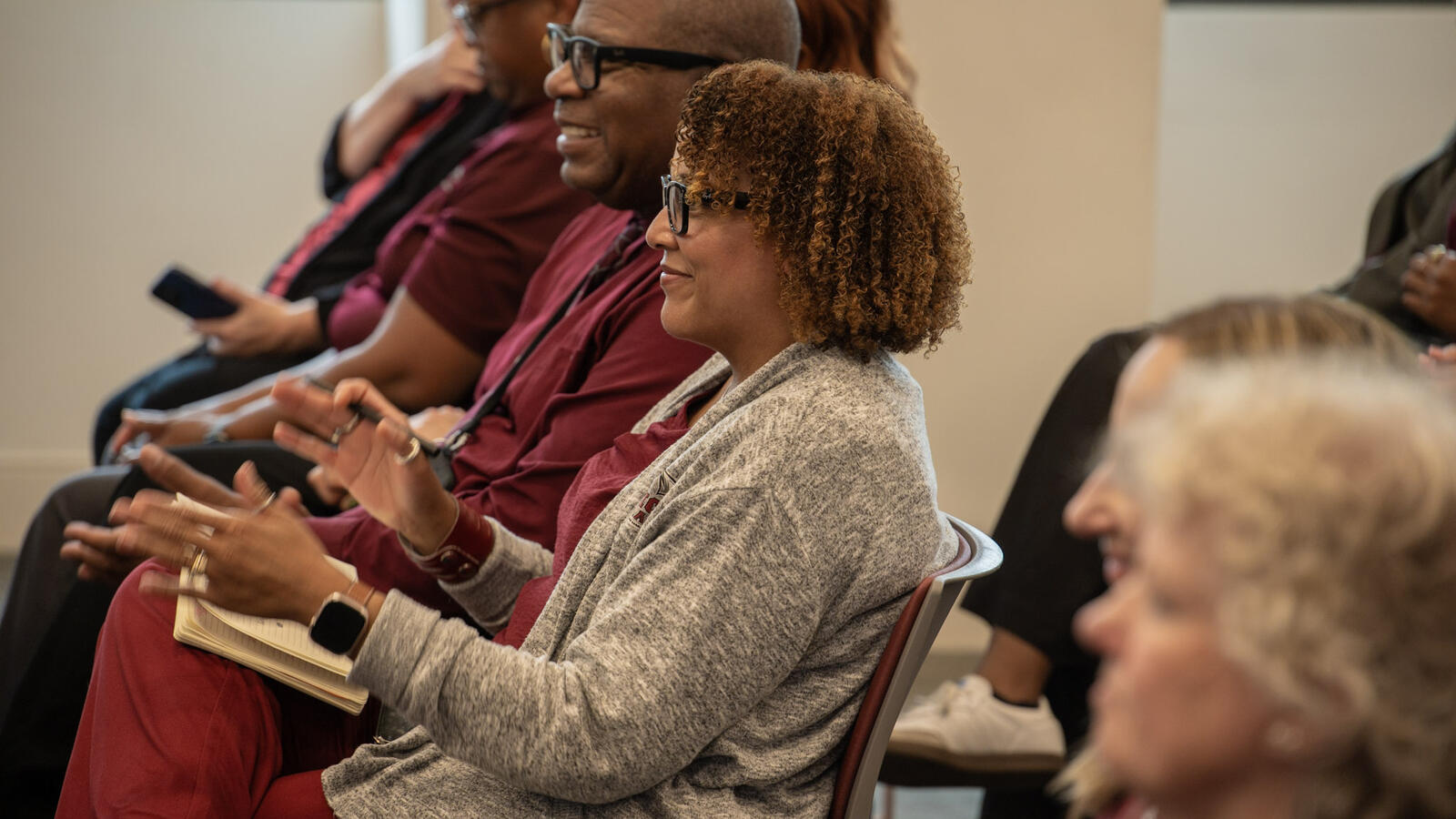 NCCU employees seated in a lecture hall listening to a university training presentation.