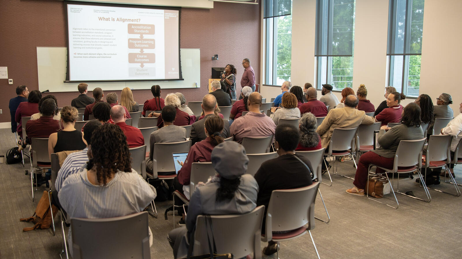NCCU faculty and staff attending a professional development session with a presentation on academic alignment.