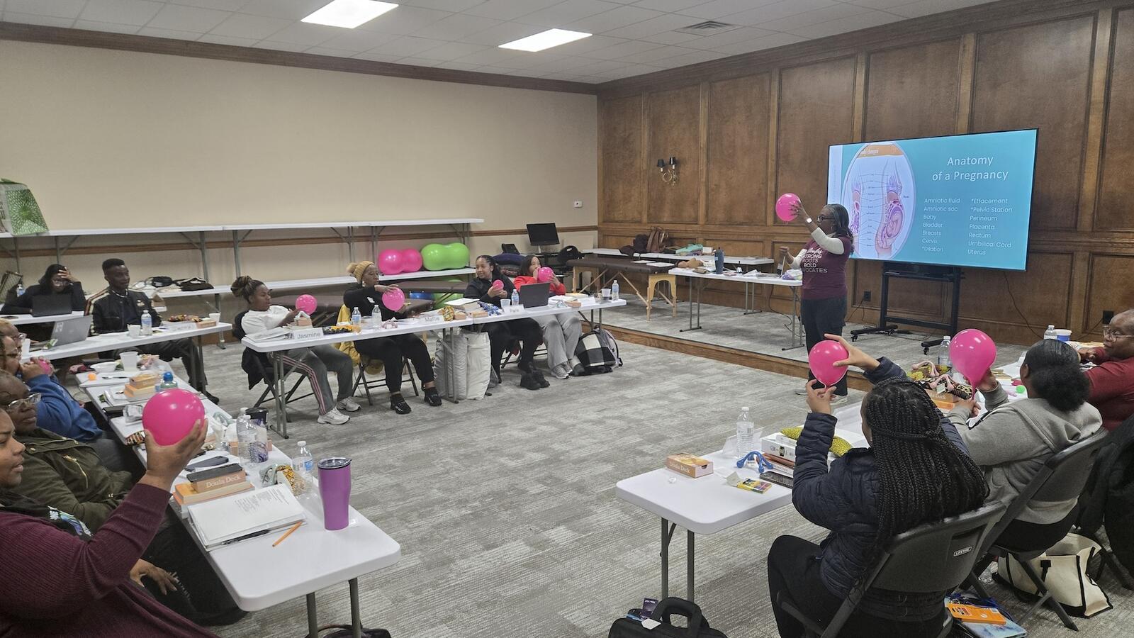 Rural Health Hub Doula Program Participants hold up a balloon as part of training