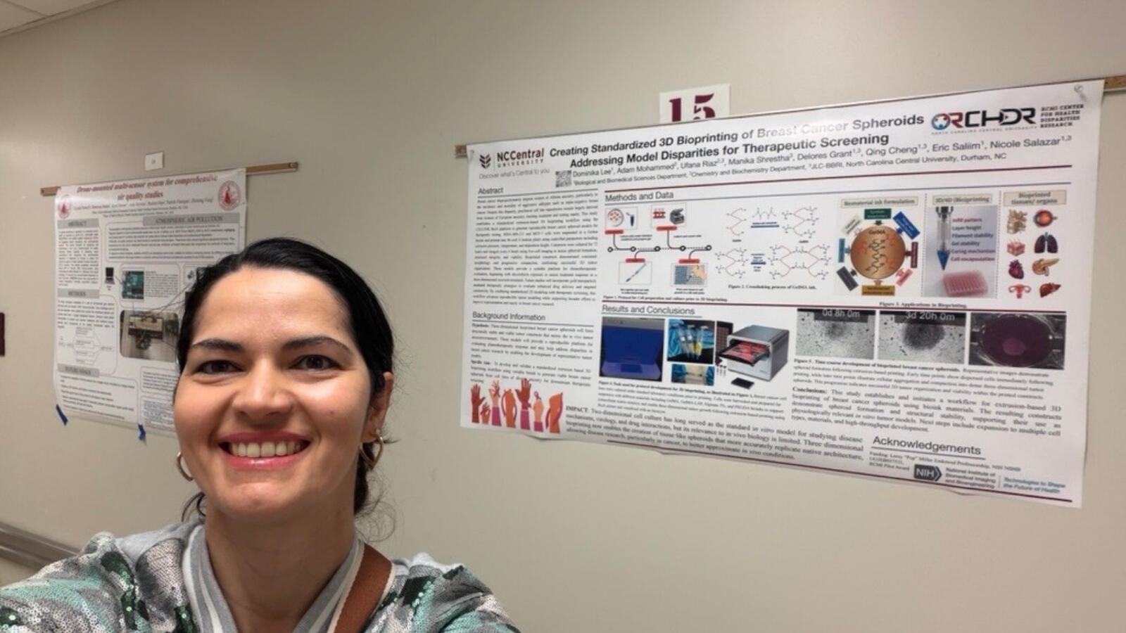Student smiling in front of scientific research poster on 3D bioprinting and therapeutic screening.