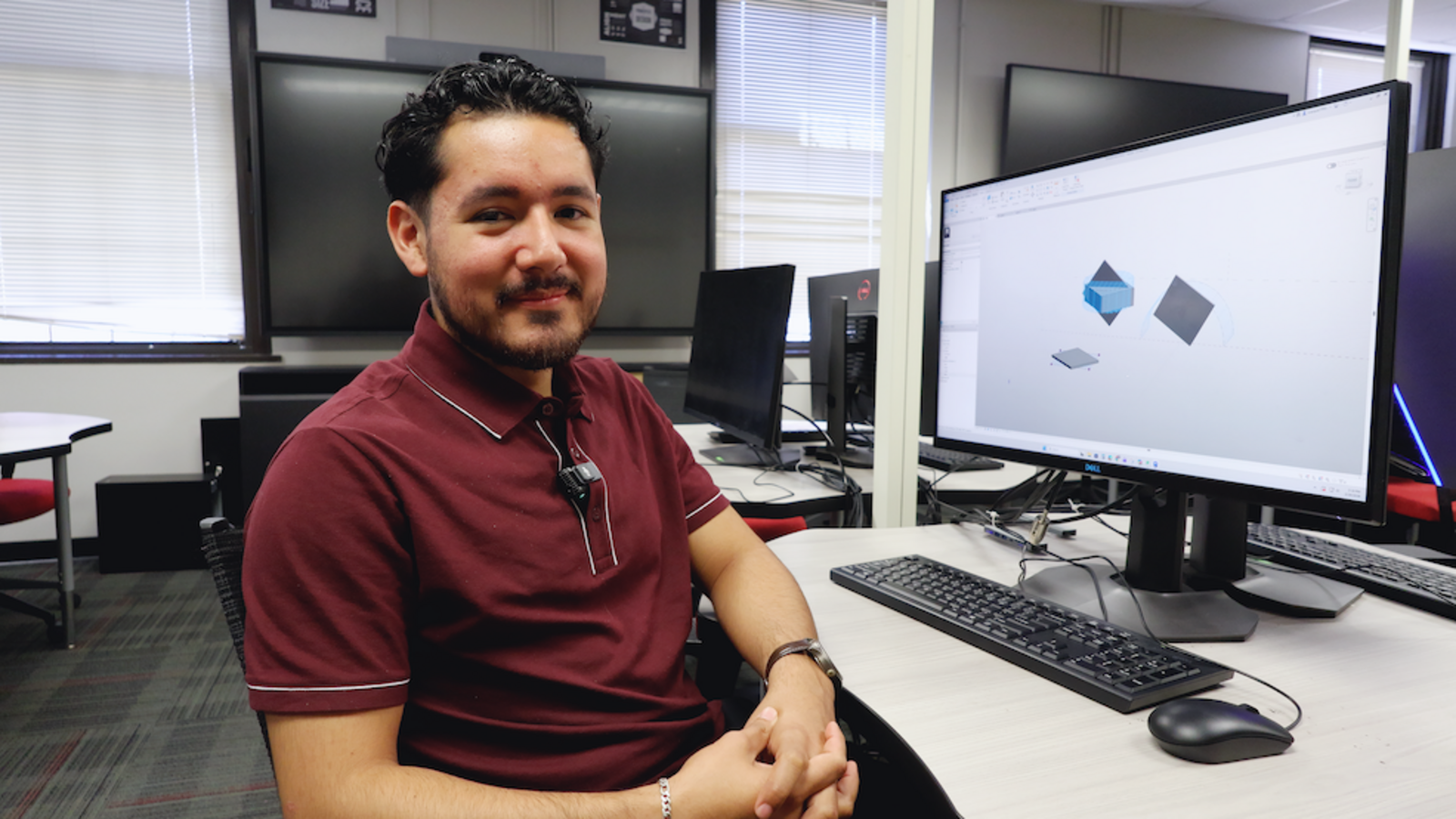 Zamir Vazquez sits in front of computer