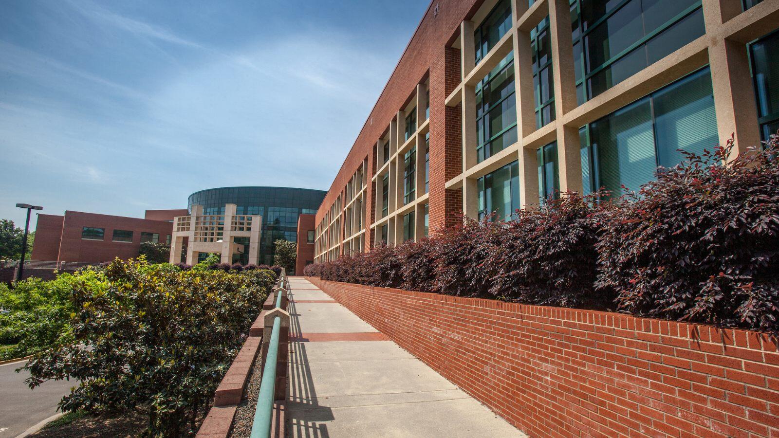 Exterior view of North Carolina Central University's School of Education with a brick walkway leading to the entrance.