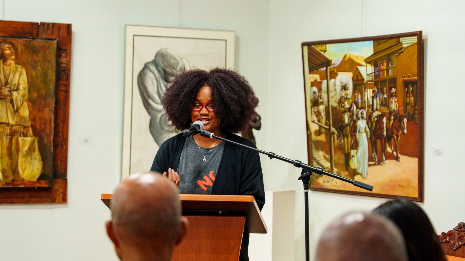 A speaker addresses the room.