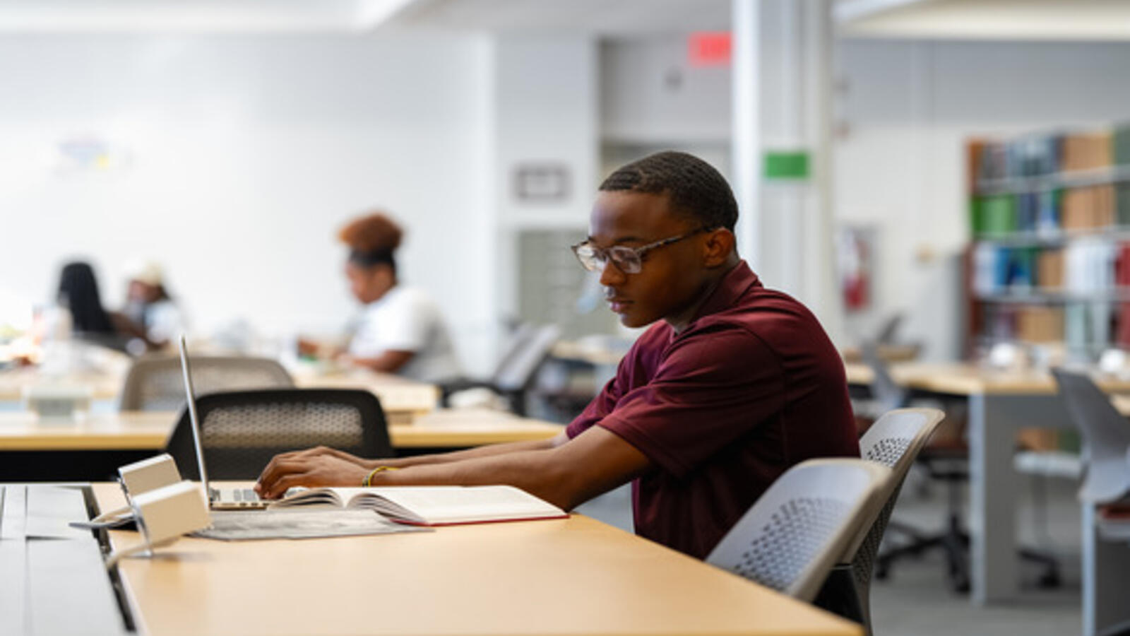 Image of man sitting at desk studying 