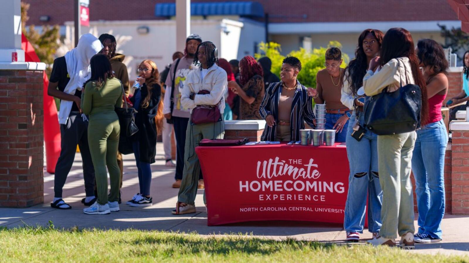 image of group of people gathering around a booth
