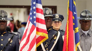 Soldiers holding American flag.
