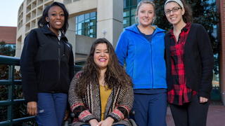 Four NCCU students standing outside the School of Education Building.