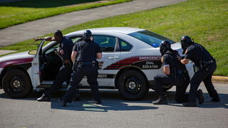University Police outside of police car.