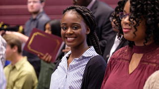 Student Smiling at a desk