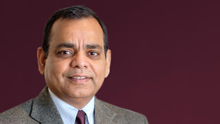 photo of Deepak Kumar in brown jacket and tie