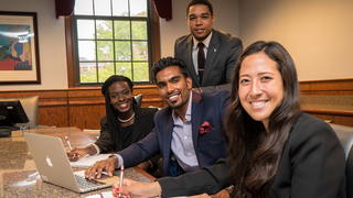 school of business students sitting at a table