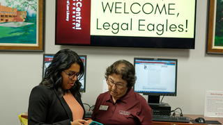 School of Law Student speaking with teacher.