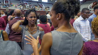 Alumni at an event talking.