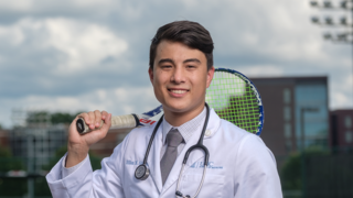 Dr. holding tennis racket 