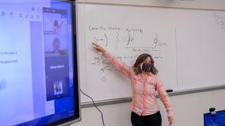 Professor is teaching on white board
