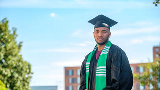 Graduate student standing outside.