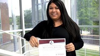 Student holding a degree