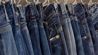 pairs of jeans hanging up