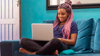 Girl on a couch with a laptop