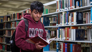 Student reading book in the library