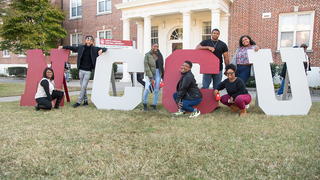 Students posing with the letters NCCU.