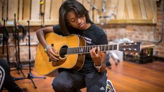 Student playing guitar