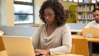 Focused student working in computer lab.