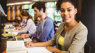 Student looking at camera while in group study