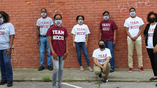 Group of People Standing in front of a wall