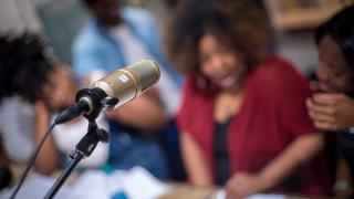 Student with microphone in foreground