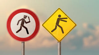 Two signs showing a police officer chasing a person