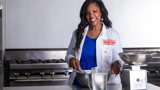 Shanae Bryant graduate in kitchen