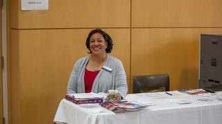 Presenter sitting at an information table