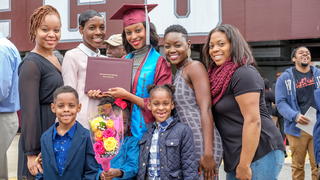 Graduating Student posing with their family