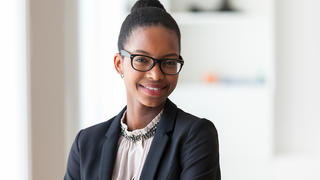 Young professional woman looking towards the camera and smiling