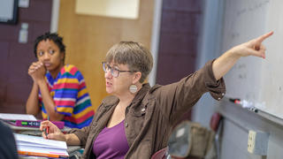 Instructor pointing to whiteboard