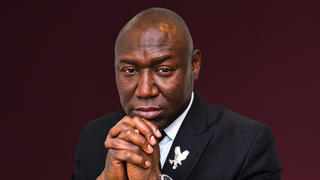 Attorney Benjamin Crump looking forward with hands clasped