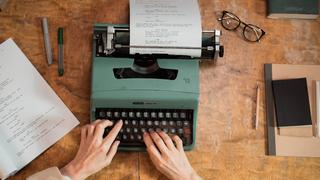 hands typing on typewriter