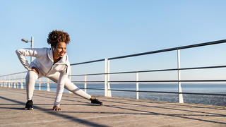 Black woman working out on the pier