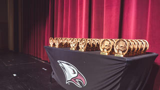 Eagle awards on a table with a black NCCU eagle tablecloth underneath