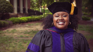 Law School graduate Brittany Reaves standing in front of building