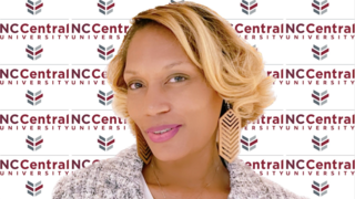 Dr. Darlene Eberhardt-Burke in front of NCCU logo