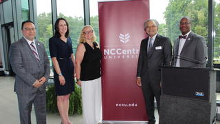 ACC-NCCU Eagle ACCess team standing in front of NCCU banner
