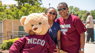 Female NCCU student with dad and teddy bear