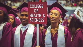 Grad Student with sign