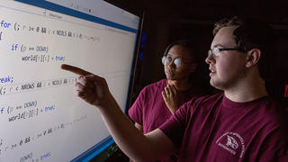 NCCU student explaining something to a classmate