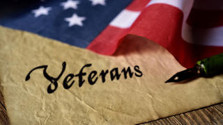 american flag with veterans written on a piece of paper